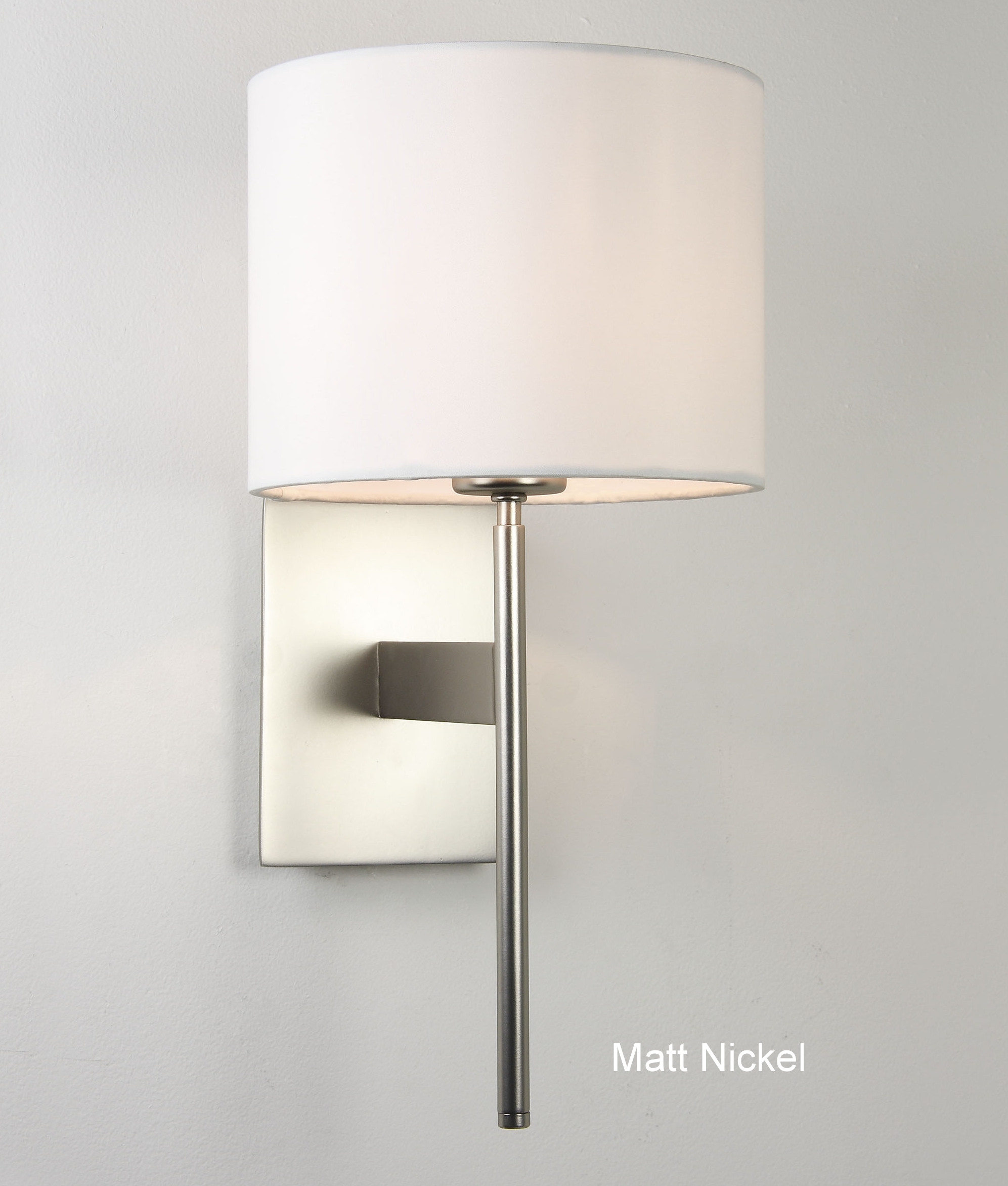 Elegant wall light with fabric shade is available in three finishes